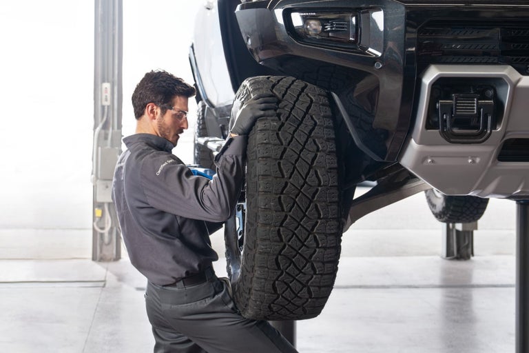 GMC Certified Service Technician preparing to remove a Wheel