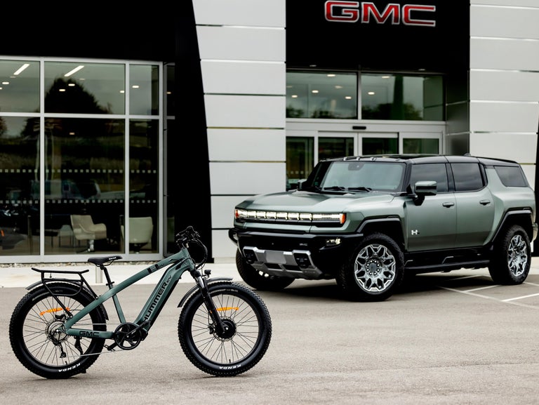 GMC Hummer EV AWD EBike with a GMC Hummer EV in a dealership lot