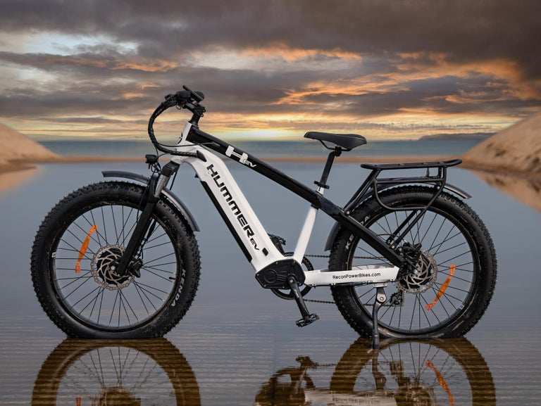 GMC Hummer EV AWD EBike on water reflecting the sunset sky